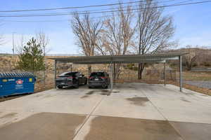 View of parking with a carport