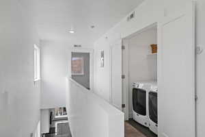 Clothes washing area featuring washing machine and dryer