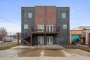 Rear view of property featuring an AC wall unit and french doors