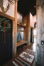 Entry way with a dressing bench a pantry, and a towering ceiling.