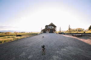 Rustic home with a large driveway, room to build an additional structure and a large shop.