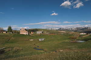 View of the 5.5 acre property that features a pond, stream and mountain view.