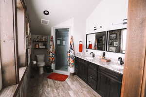 Primary Suite bathroom with a walk in shower and granite countertops.