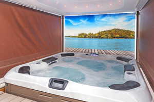 Exterior space with a water view and an outdoor hot tub