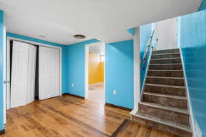 Stairway featuring hardwood / wood-style flooring