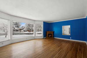 Unfurnished living room featuring hardwood / wood-style floors