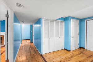 Corridor with light wood-type flooring