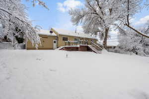 View of snow covered rear of property