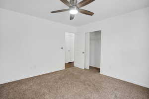 Unfurnished bedroom featuring carpet floors, a closet, a ceiling fan, and baseboards