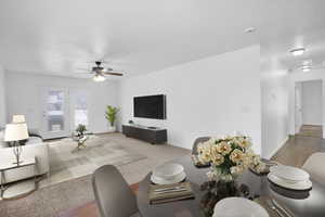 Dining area with baseboards, a ceiling fan, and light colored carpet