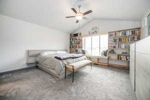 Bedroom featuring ceiling fan, lofted ceiling, and carpet floors