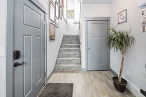 Stairway with baseboards and wood finished floors