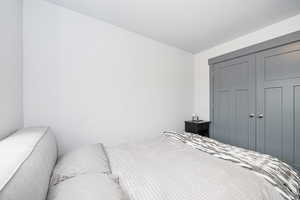 Bedroom featuring a closet and a textured ceiling