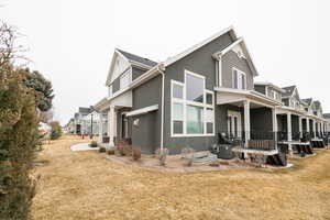 View of side of property with central AC, a residential view, stucco siding, and a yard