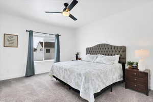 Bedroom with carpet floors, ceiling fan, and baseboards