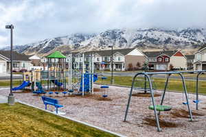 Community playground with a residential view and a mountain view