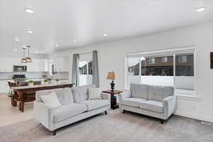 Living area with recessed lighting, visible vents, and baseboards