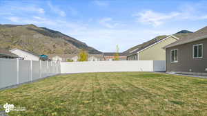 View of yard with a mountain view and a fenced backyard