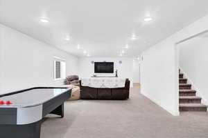 Rec room with light carpet, recessed lighting, and baseboards