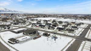 Snowy aerial view featuring a residential view and a mountain view