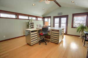 Office area with baseboards, lofted ceiling with beams, a textured ceiling, french doors, and light wood-style floors