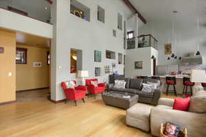 Living area with light wood finished floors and baseboards