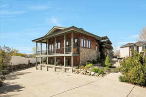 View of home's exterior with stone siding and fence