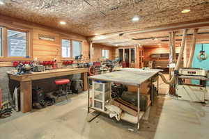 Misc room featuring concrete flooring and a workshop area