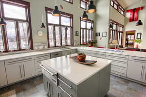 Kitchen featuring hanging light fixtures, light countertops, and a center island