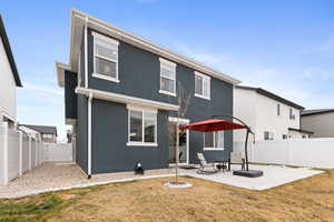 Back of house with a patio area, a yard, a fenced backyard, and stucco siding