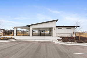 View of pool clubhouse building exterior with a fence