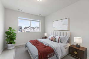 Bedroom with carpet flooring, visible vents, and baseboards