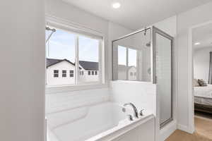 Full bath with a garden tub, recessed lighting, ensuite bathroom, a shower stall, and wood finished floors