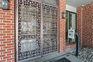 Doorway to property with brick siding