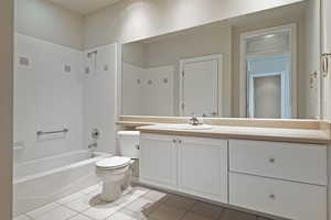 Full bath featuring toilet, bathing tub / shower combination, tile patterned flooring, and vanity