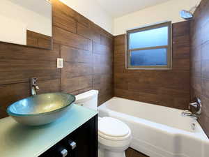 Full bathroom with toilet, bathtub / shower combination, and vanity