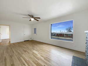 Empty room featuring a ceiling fan, light wood-type flooring, and baseboards