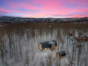 Snowy aerial view featuring a mountain view