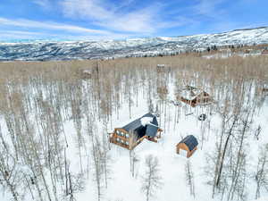 Snowy aerial view featuring a mountain view