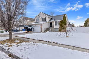 View of property with 2 car garage +RV space