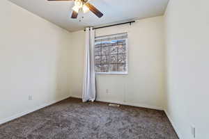 Carpeted bedroom with ceiling fan