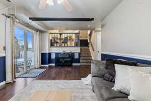 Living room, wood-type flooring, Wainscoting, glass slider to patio