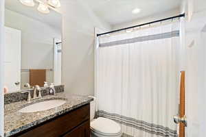 Full bathroom with vanity and toilet