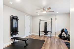 Exercise area featuring ceiling fan, recessed lighting, wood finished floors, visible vents, and baseboards