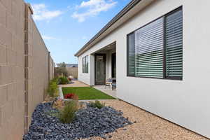Exterior space featuring a patio area, a fenced backyard, and stucco siding