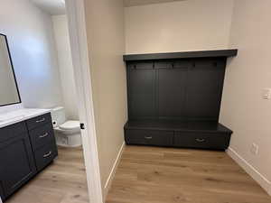 Mudroom featuring light wood-type flooring and baseboards