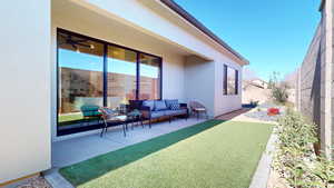 Exterior space with a fenced backyard and an outdoor hangout area