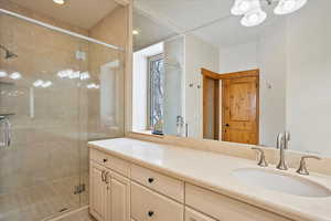 Bathroom featuring a stall shower and vanity