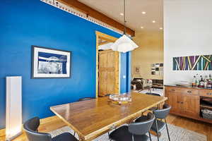 Dining room featuring light wood-type flooring and recessed lighting