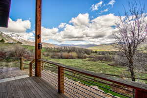 Wooden deck with a mountain view and a rural view